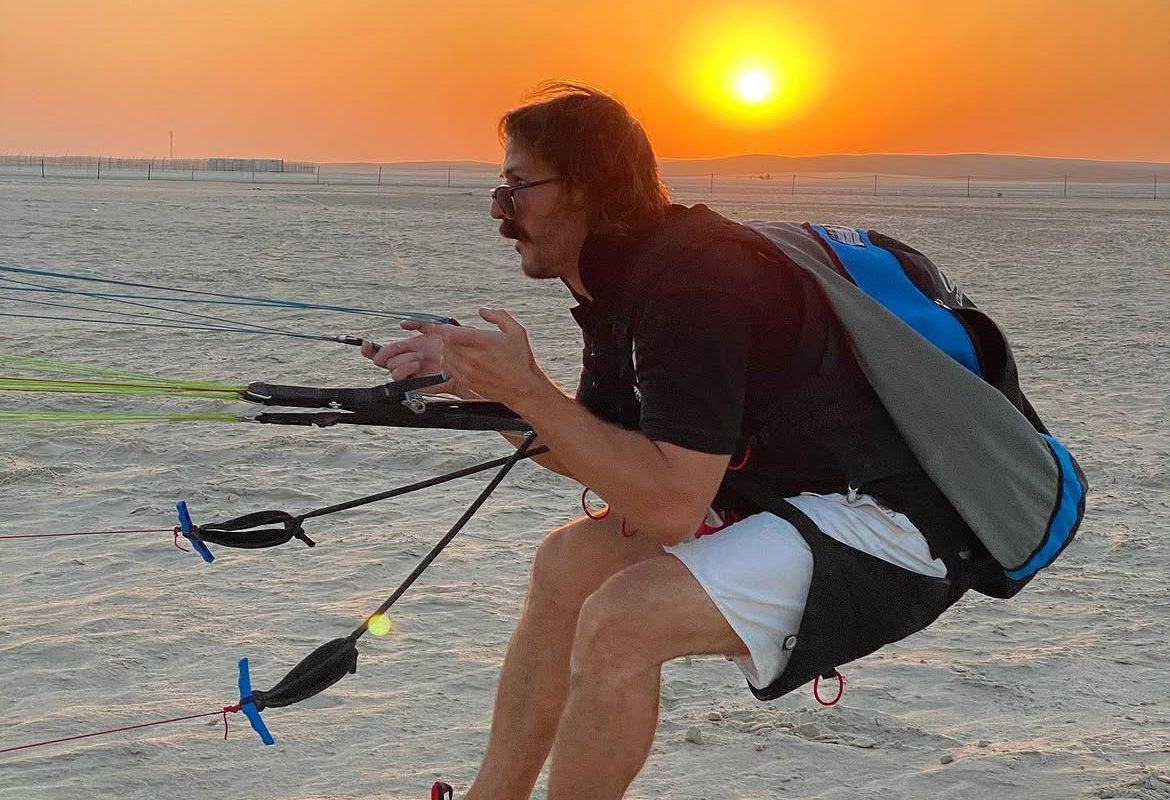 Javi crouched mid-air at sunset